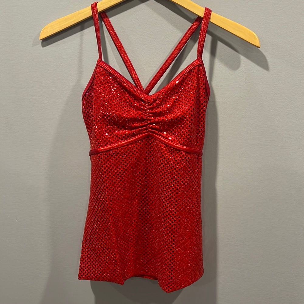 Red sparkly cross strap top for dance or baton twirling.